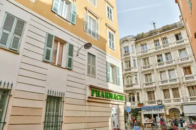 a sign for a pharmacy on the side of a building at L'Olivette in Nice