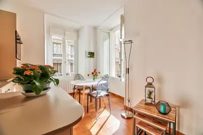 a kitchen with a table and chairs in a room at L'Olivette in Nice