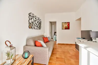 a living room with a couch and a table at L'Olivette in Nice
