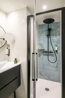 a shower with a glass door in a bathroom at Best Western Alba in Nice