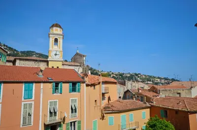 a city with a clock tower in the background at Villefranche Sur Mer One Bed in Villefranche-sur-Mer