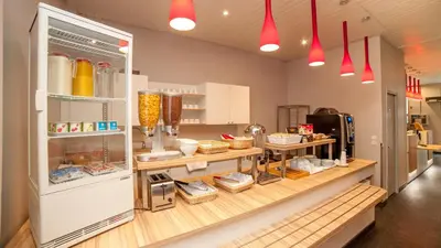 a kitchen with an open refrigerator with food inside at Hôtel Amaryllis in Nice