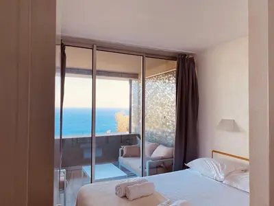 a hotel room with a view of the ocean at Sunny Home Costa Plana-Monaco -Cap D'Ail in Cap d'Ail