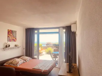 a bedroom with a bed and a view of a balcony at Sunny Home Costa Plana-Monaco -Cap D'Ail in Cap d'Ail