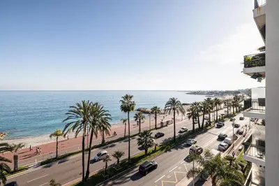 a view of a street with palm trees and the ocean at Sea view - 2 Bdr Promenade des Anglais in Nice