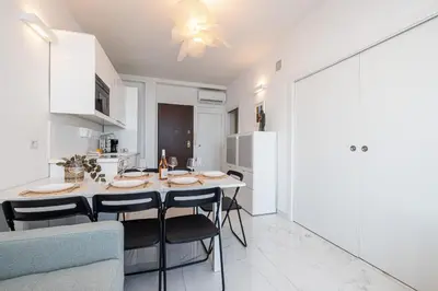 a kitchen and dining room with a table and chairs at Sea view - 2 Bdr Promenade des Anglais in Nice
