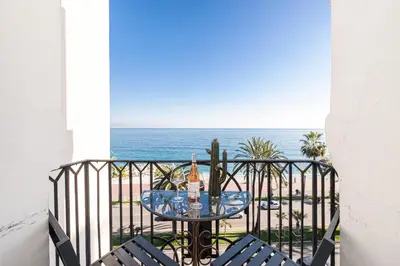 a table on a balcony with a view of the ocean at Sea view - 2 Bdr Promenade des Anglais in Nice