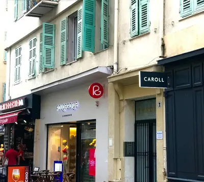 a store with a sign on the side of a building at Boutique Hôtel Neptune Nice in Nice