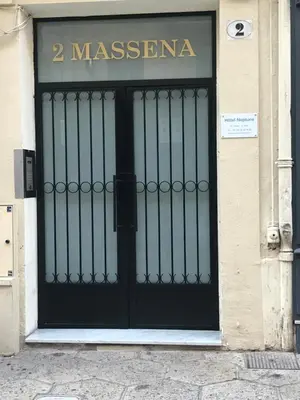 a black door on a building with a sign on it at Boutique Hôtel Neptune Nice in Nice