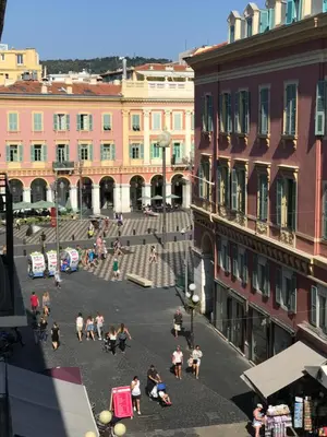 a group of people walking around in a city at Boutique Hôtel Neptune Nice in Nice