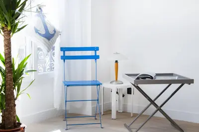 a blue chair next to a desk and a table at MY CASA - 48 GIOFFREDO - NEAR PLACE MASSENA in Nice