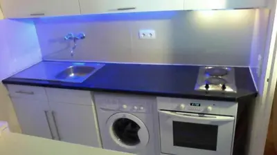 a kitchen with a sink and a washing machine at Beachfront apartment Promenade Des Anglais in Nice