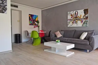 a living room with a couch and a table at Royal Lux NICE -Last floor, see view in Nice
