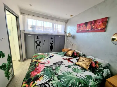 a bedroom with a bed with a colorful bedspread at Royal Lux NICE -Last floor, see view in Nice