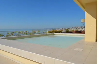 a swimming pool with a view of the ocean at Royal Lux NICE -Last floor, see view in Nice