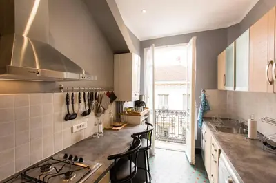 a kitchen with a sink and a stove top oven at Appartement carre d'or in Nice