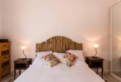 a bedroom with a white bed with two lamps at Appartement carre d'or in Nice