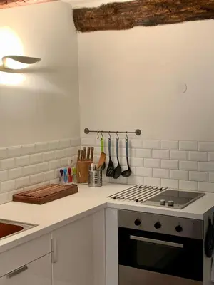 a kitchen with a stove top oven next to a counter at Rue Neuve - Old Town Apartment in Nice