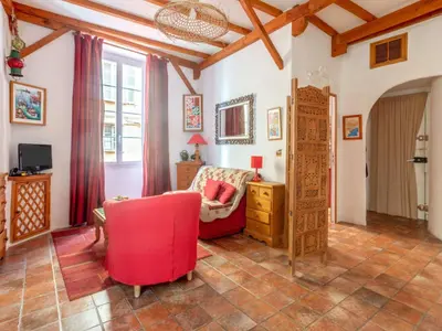 a living room with a red chair and a desk at Apartment Miralheti by Interhome in Nice