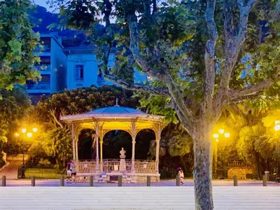 a gazebo in a park at night at Hotel Select in Beaulieu-sur-Mer