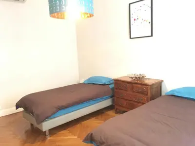 a bedroom with two twin beds and a dresser at Palais Haydee in Nice