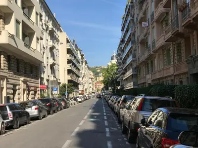 a row of cars parked on the side of a street at Palais Haydee in Nice
