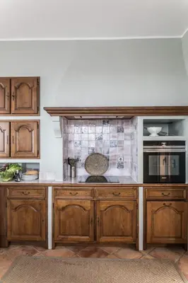 a kitchen with wooden cabinets and a counter top at Stunning seaview villa. Villefranche Sur Mer in Villefranche-sur-Mer