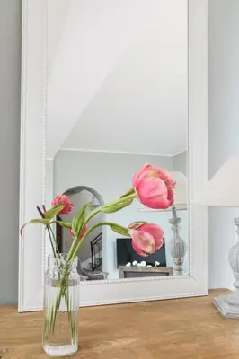 a vase with pink flowers in front of a mirror at Stunning seaview villa. Villefranche Sur Mer in Villefranche-sur-Mer