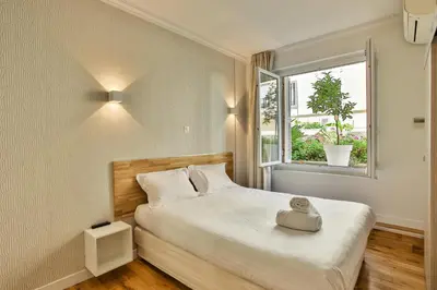 a bedroom with a bed with a toy on it at Nice Home - Studios Lido in Nice