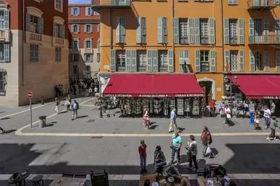 a group of people walking around a street with buildings at MY CASA - PAULE - Great Old Town Studio w AC in Nice