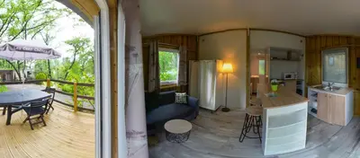 a room with a kitchen and a living room at Camping Les Cent Chênes in Saint-Jeannet