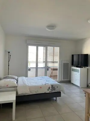 a bedroom with a bed and a flat screen tv at beau studio in Nice