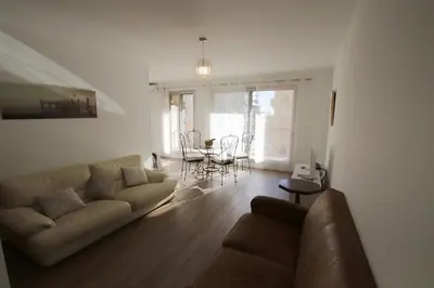 a living room with a couch and a table at Le Renoir in Nice