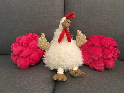 a stuffed chicken is sitting on a couch at Riviera Terrasse - parking gratuit in Nice