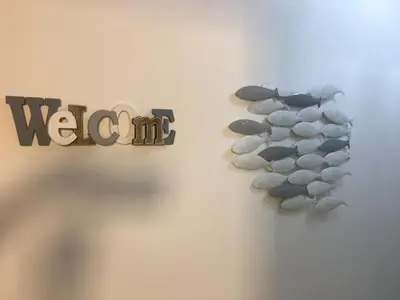 a wall with a pebble clock and the word watch at Riviera Terrasse - parking gratuit in Nice