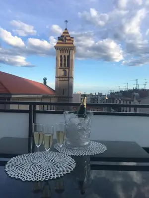a table with two glasses of wine on a balcony at Riviera Terrasse - parking gratuit in Nice