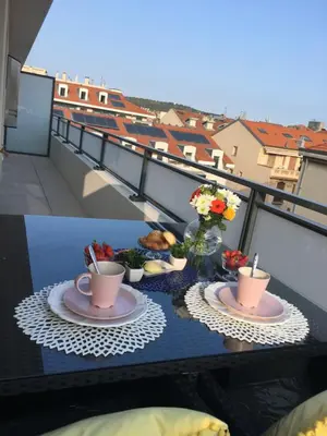 a table with plates of food and coffee on a balcony at Riviera Terrasse - parking gratuit in Nice