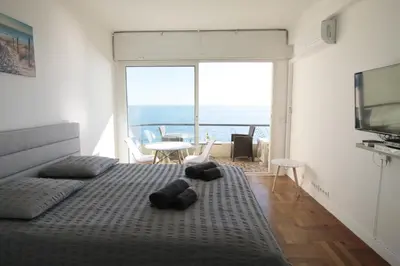 a bedroom with a bed with teddy bears on it at Promenade des anglais Vue mer in Nice