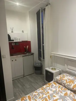 a small bedroom with a bed and a kitchen at iNICE in Nice