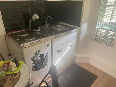 a small kitchen with a sink and a table at iNICE in Nice