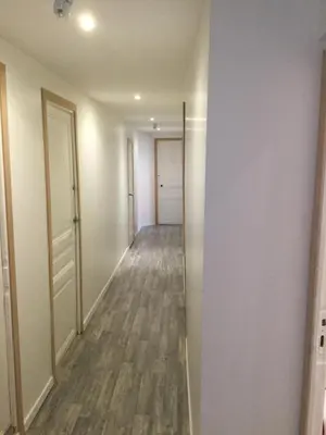 an empty hallway with a hallway leading to a door at iNICE in Nice