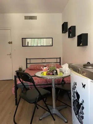 a small room with a table and a bed at iNICE in Nice