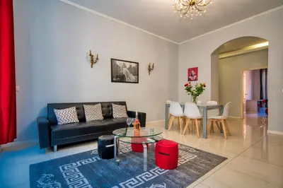 a living room with a couch and a table at Lusso 5 beds Central Apartment in Nice