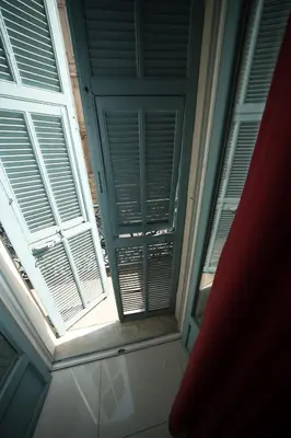 a window in a building with blinds on it at Lusso 5 beds Central Apartment in Nice