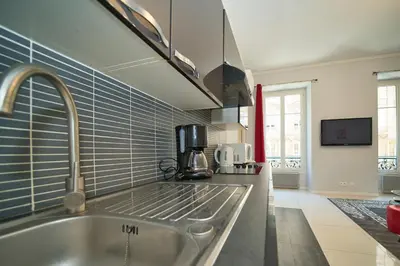 a kitchen with a sink and a counter top at Lusso 5 beds Central Apartment in Nice