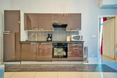a kitchen with stainless steel appliances in a room at Lusso 5 beds Central Apartment in Nice