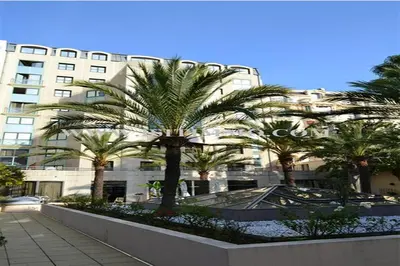 a large building with palm trees in front of it at Superbe Studio in Nice at 450m from the sea with Clim in Nice