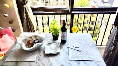 a bottle of wine sitting on a table on a balcony at Luxurious Studio in NICE 450 m of the sea in Nice