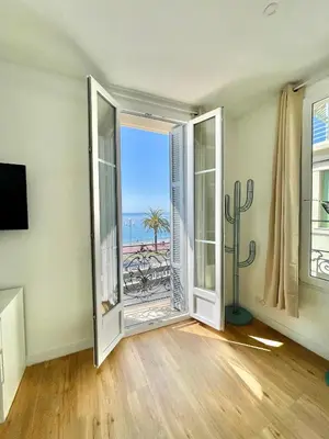 a room with an open door with a view of the ocean at Promenade des Anglais panoramic sea view in Nice