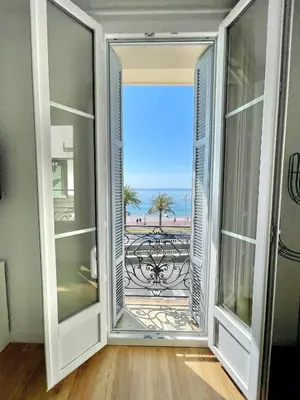 an open door with a view of the ocean at Promenade des Anglais panoramic sea view in Nice